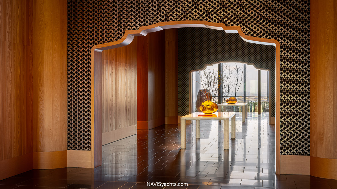 The luxurious 40th-floor lounge of the Bvlgari Hotel Tokyo, showcasing the fusion of Italian design and Japanese craftsmanship with its elm wood panels, a grand fireplace, and elegant Italian furnishings.