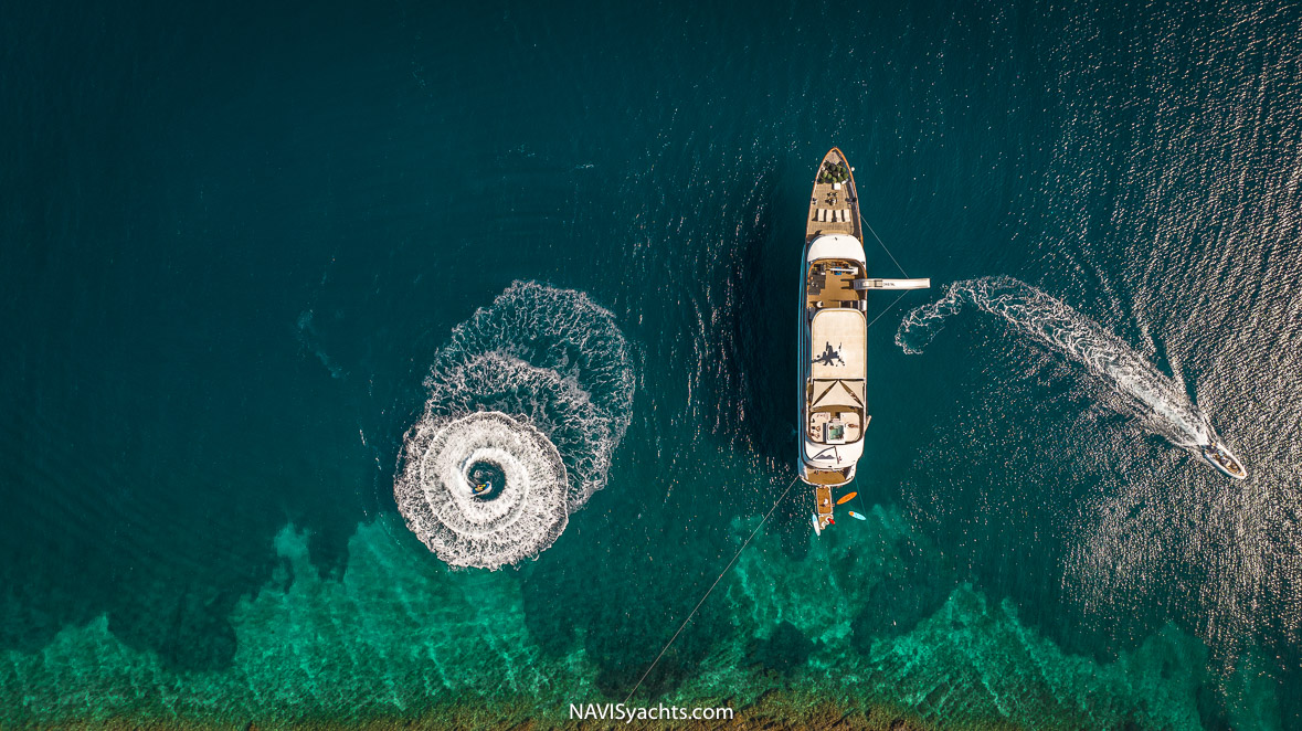 Guests enjoying water sports like jet skiing and paddleboarding in the clear waters of the Adriatic Sea near Vis island.