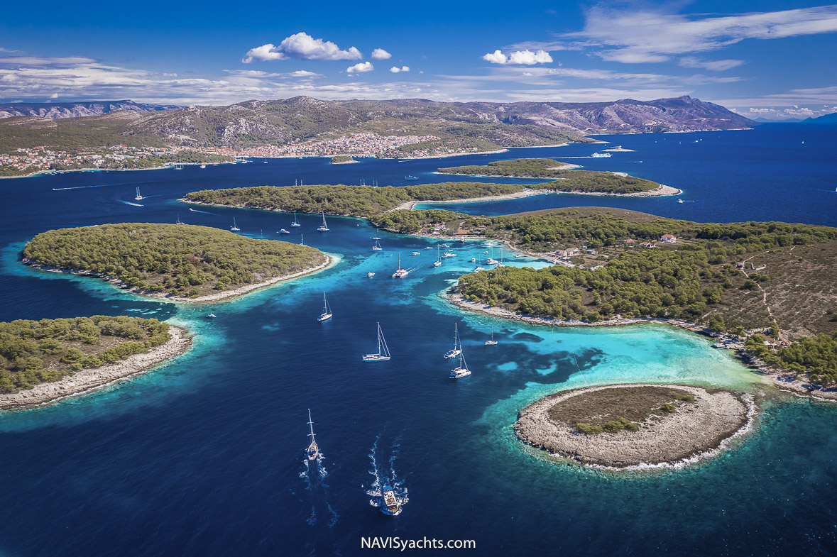 Breathtaking sunset over Hvar island, with views of medieval architecture and yachts in the harbor.