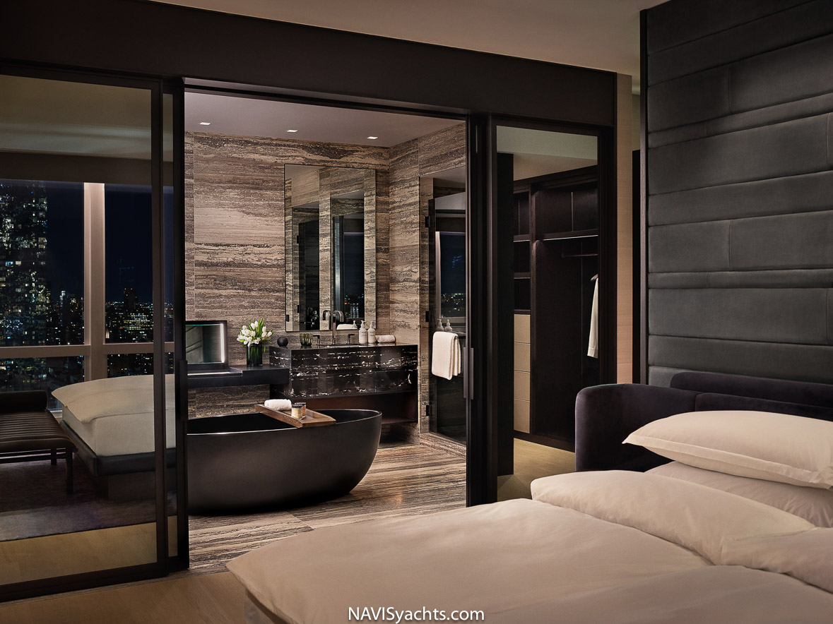 Luxurious bathroom with dark stone walls and roomy shower at Equinox Hotel