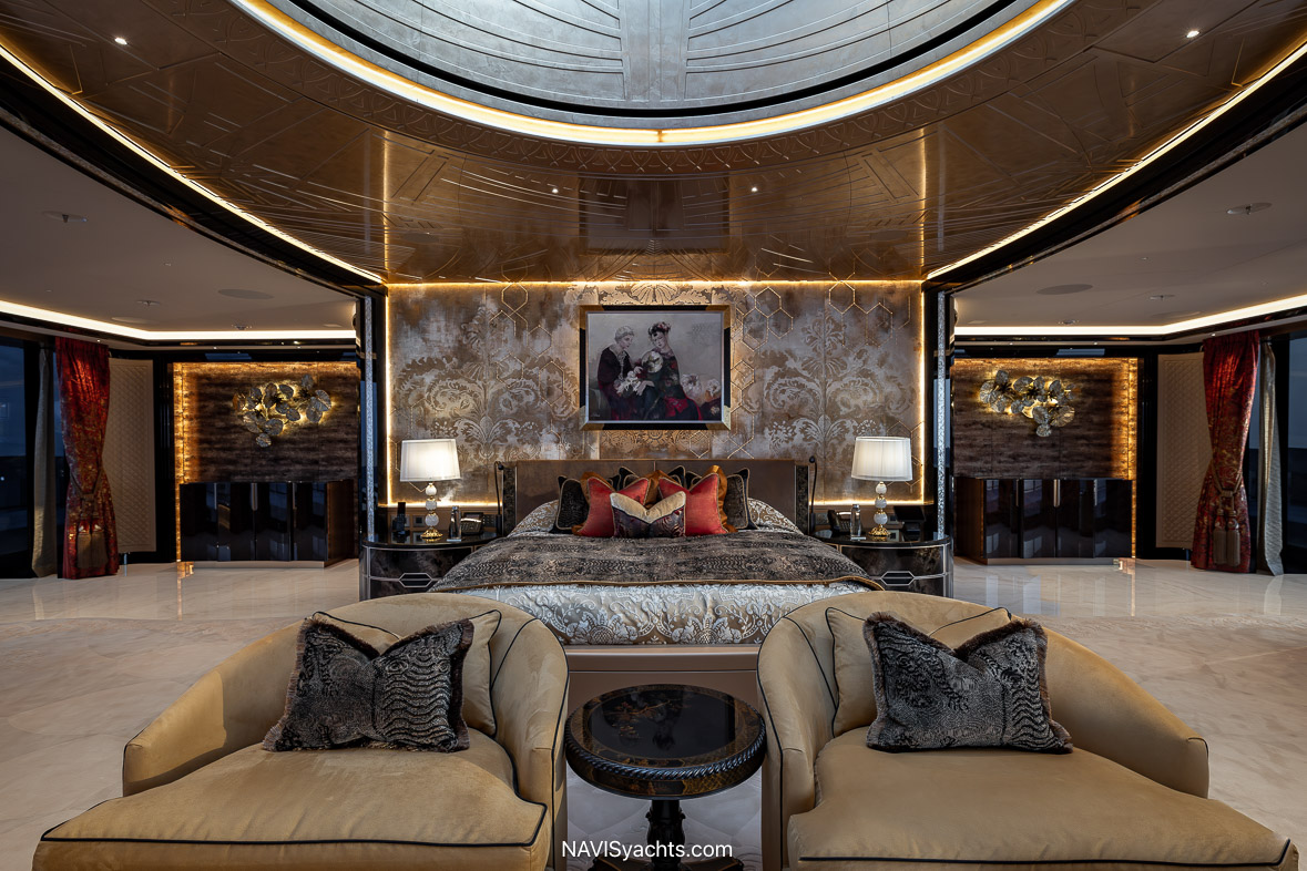 Luxurious owner’s cabin aboard Kismet featuring a king-size bed, elegant wood paneling, and expansive windows for panoramic views.