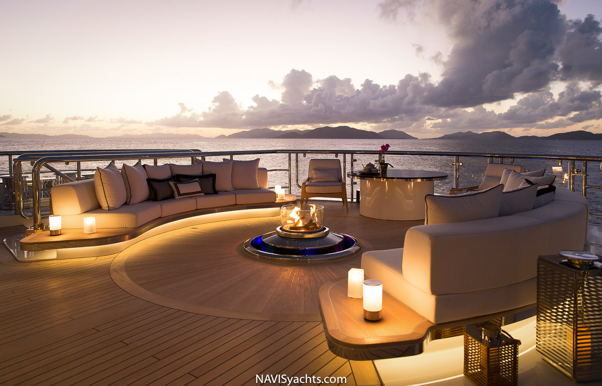 Guests enjoying post-race celebrations on the deck of Kismet, with the idyllic Caribbean scenery in the background