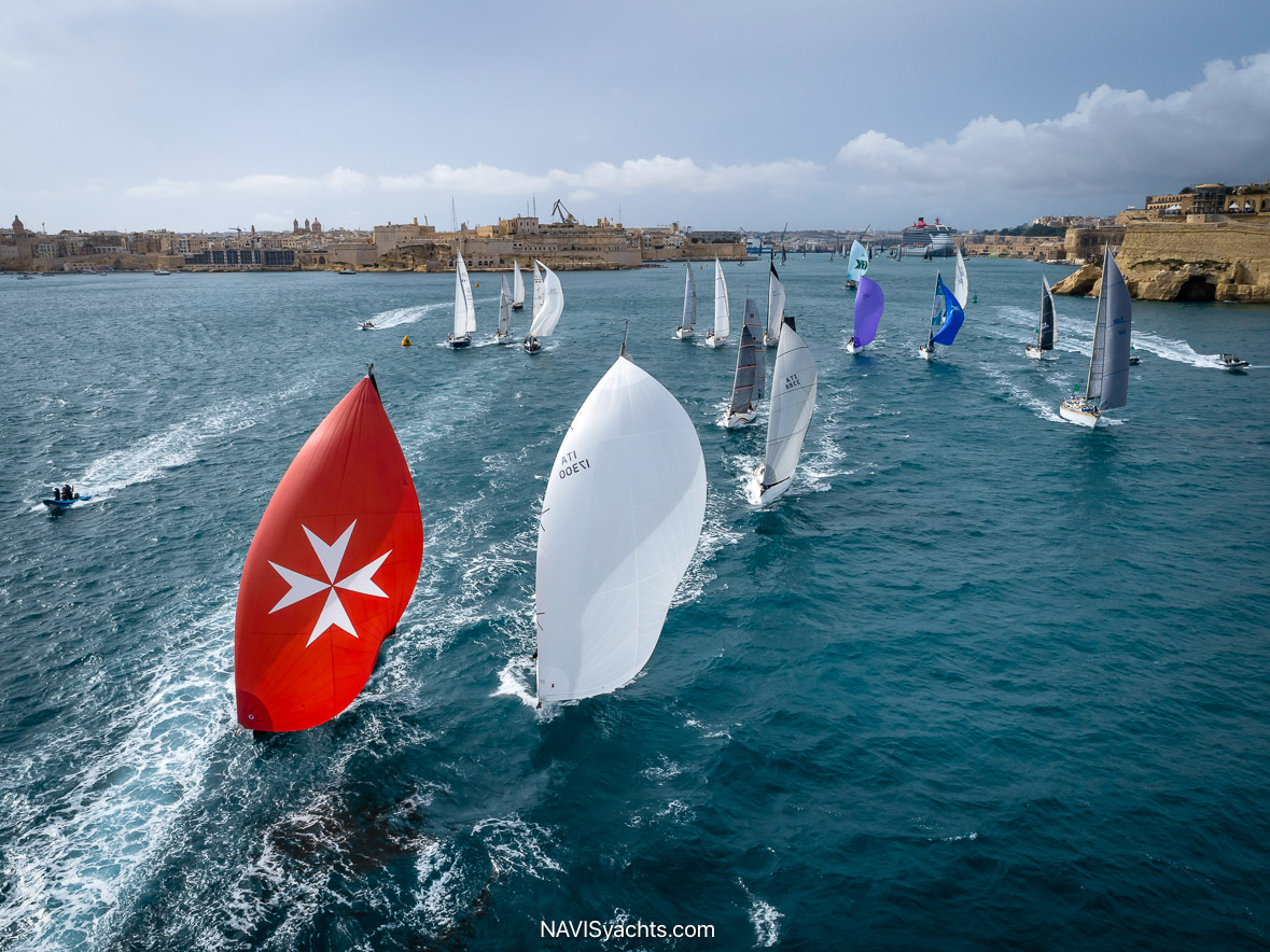 Rolex Middle Sea Race fleet departing Malta’s Grand Harbour, framed by historic Valletta fortifications.