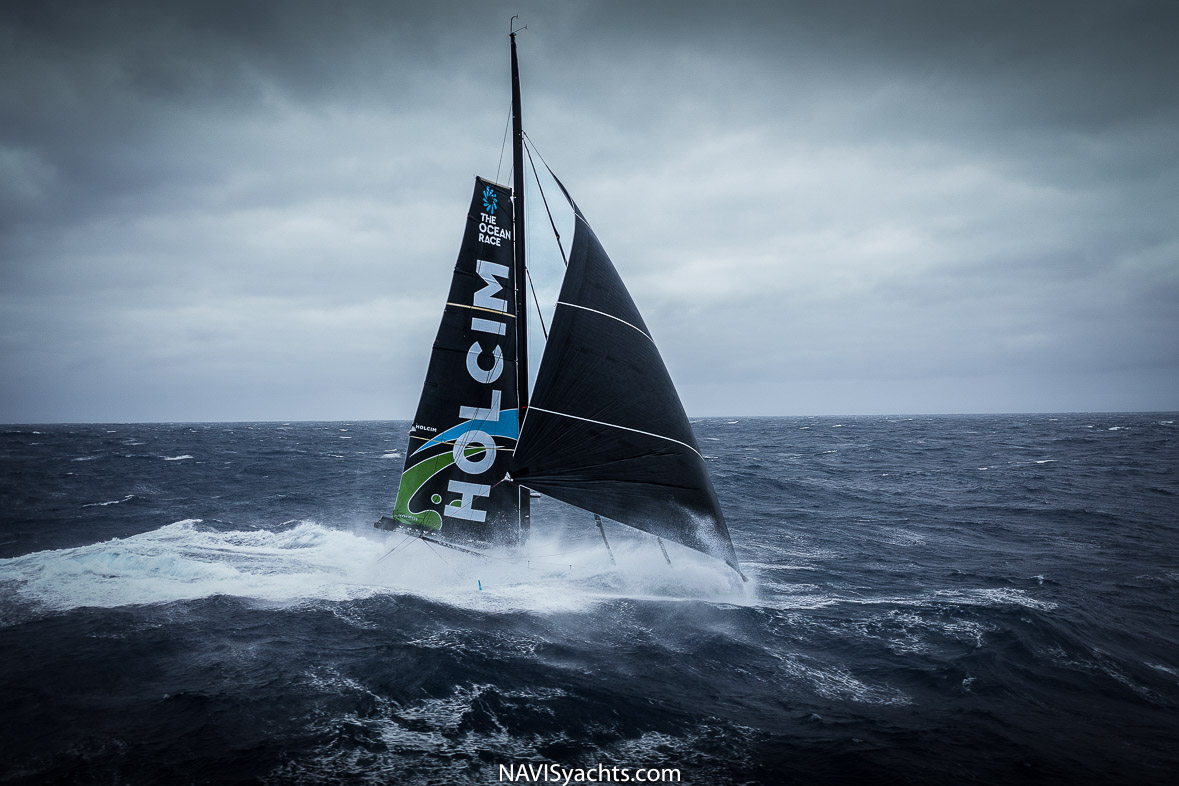 IMOCA yacht cutting through the waves during the Ocean Race 