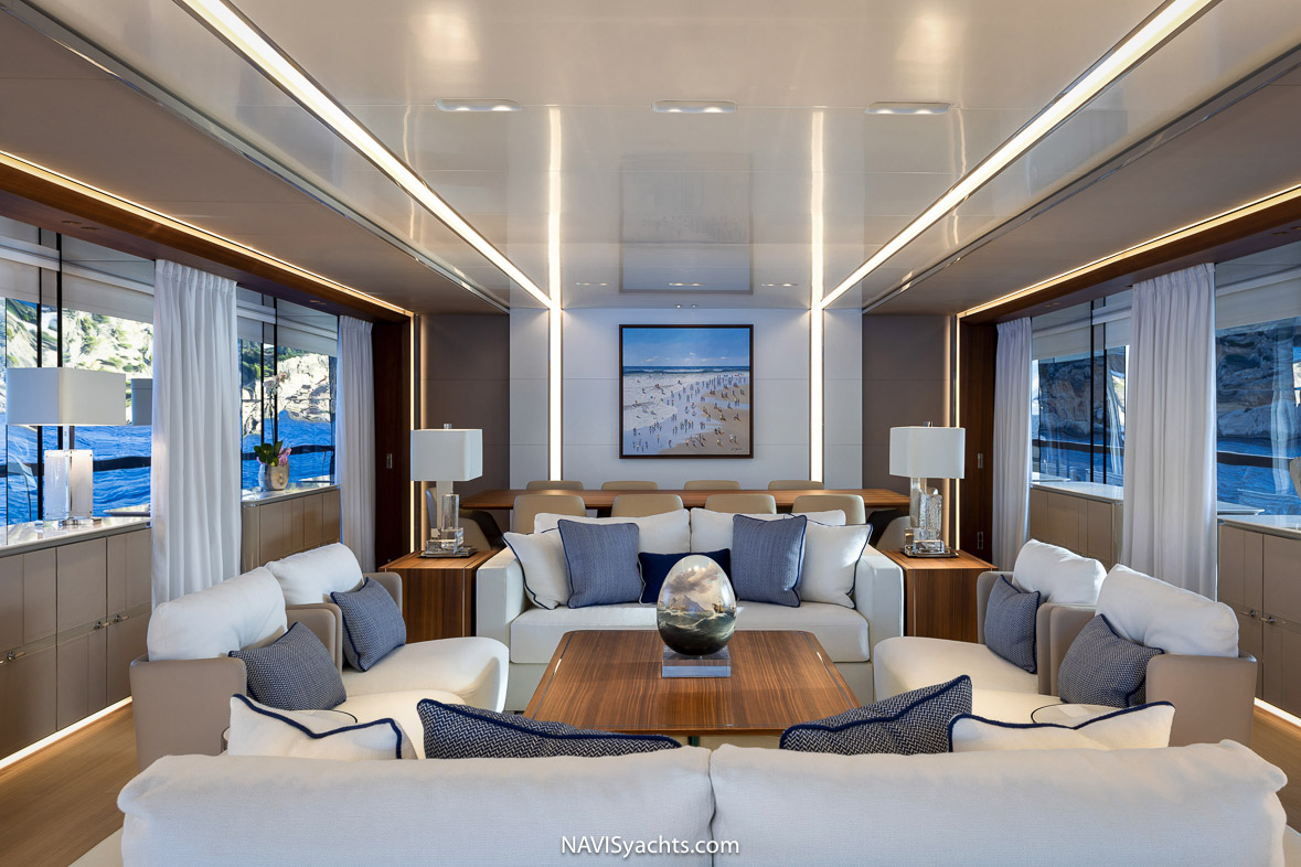 Spacious salon of superyacht Piacere with natural light filtering through.