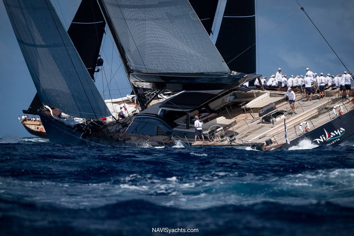 Action shot of the yacht Freya racing around St. Barthelemy, capturing the competitive spirit and beautiful setting of the Bucket Regatta.